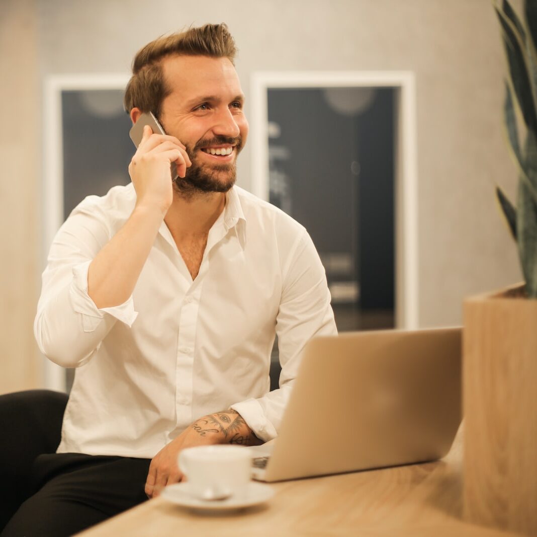 man using smartphone on chair